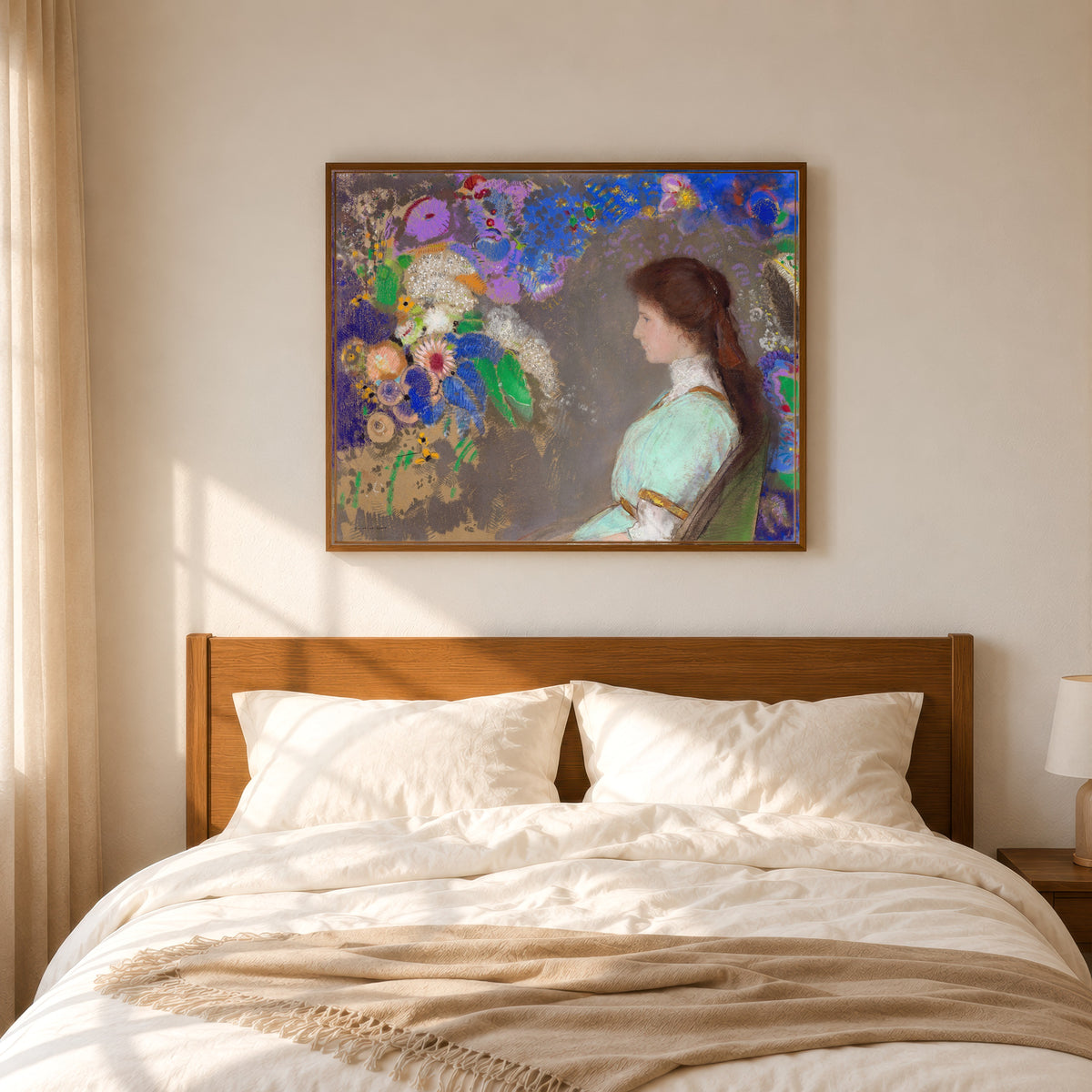 Framed art print of Violette Heymann by Odilon Redon, in a slim wood frame above a bed in a sunlit bedroom