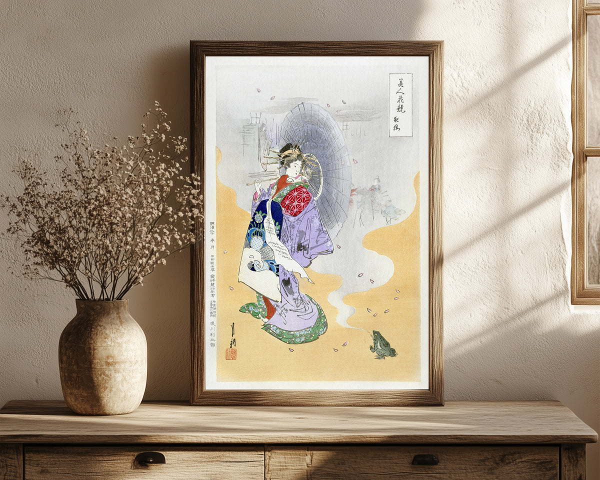 Framed art print of Courtesan and Frog (1887–1896) by Ogata Gekkō, in a dark wood frame leaning on a rustic console beside dried flowers