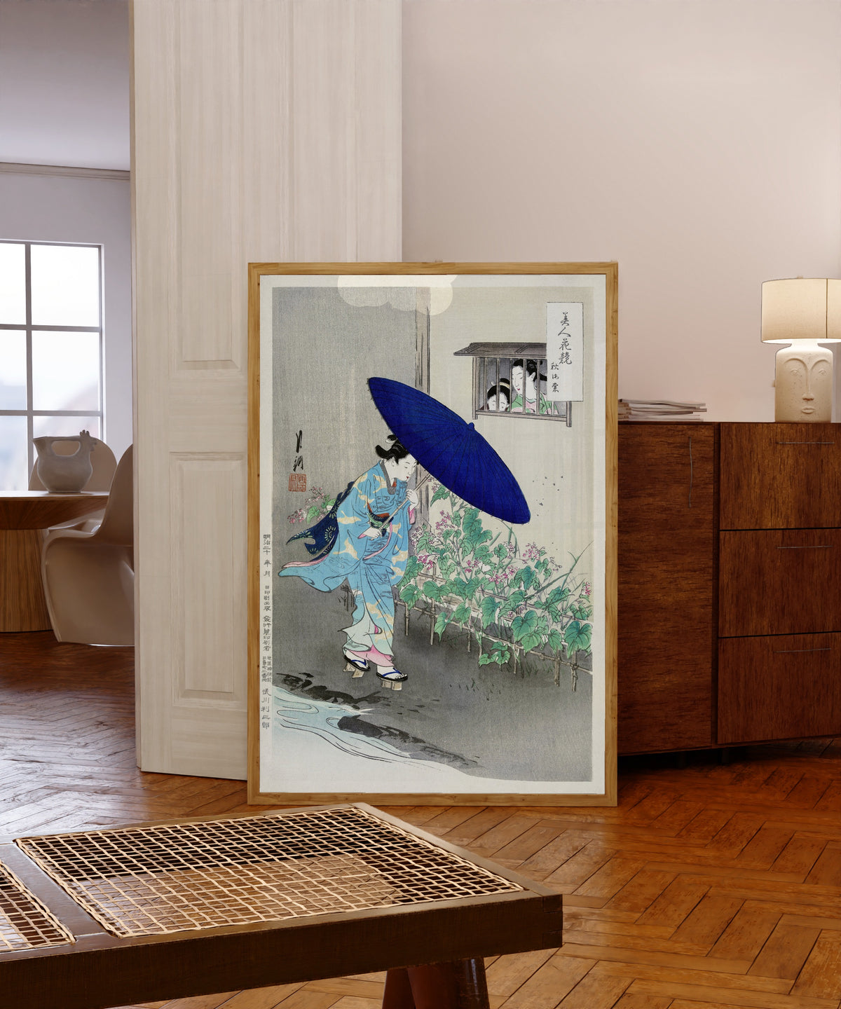 Framed art print of Flowering Hedge (1887–1896) by Ogata Gekkō, in a light wood frame leaning in a warm room with a parquet floor