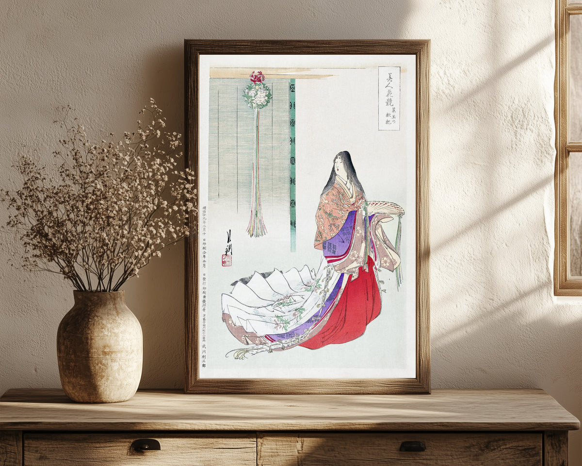 Framed art print of Heian Lady Waiting (1896) by Ogata Gekkō, in a dark wood frame leaning on a rustic console beside dried flowers