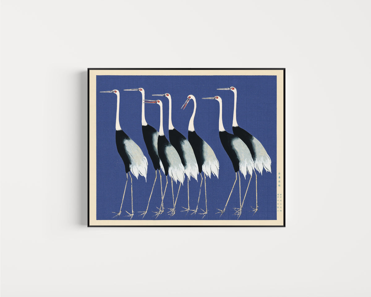 Framed art print of Cranes in Blue by Ogata Korin, in a slim black frame on a plain white wall