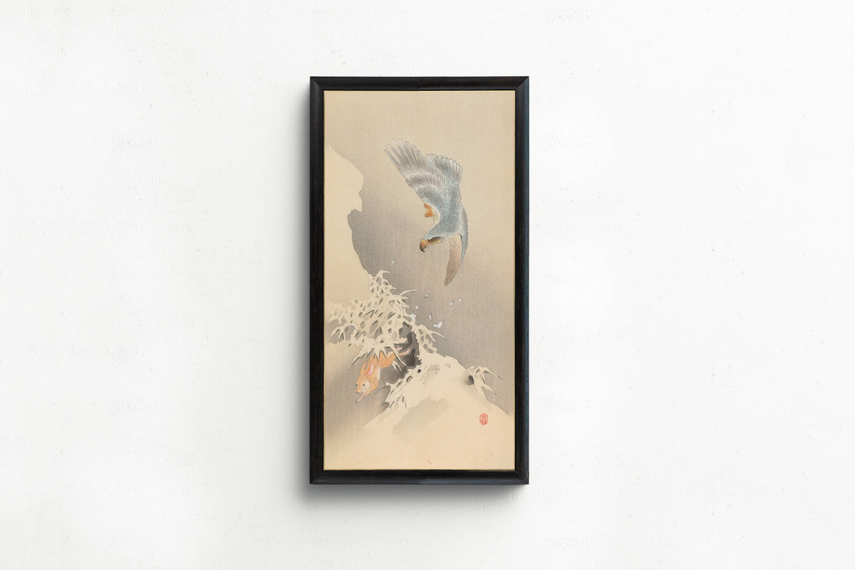 Goshawk Chasing a Hare by Ohara Koson — shown framed on a wall