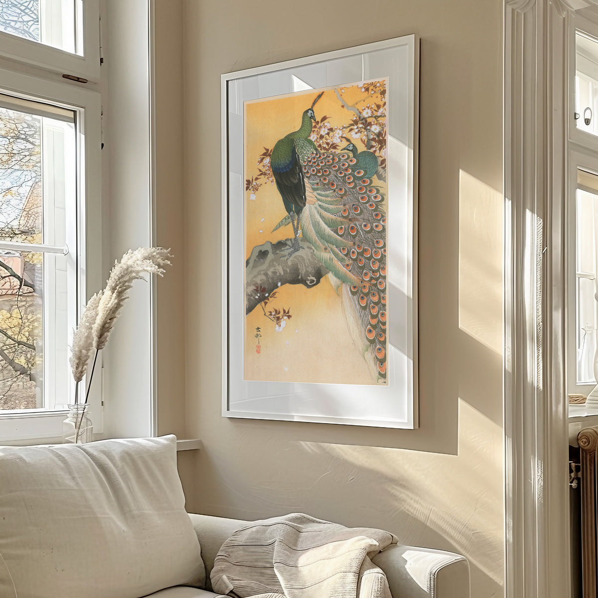 Pair of Peacocks on Cherry by Ohara Koson — framed in a sunlit living room above a sofa
