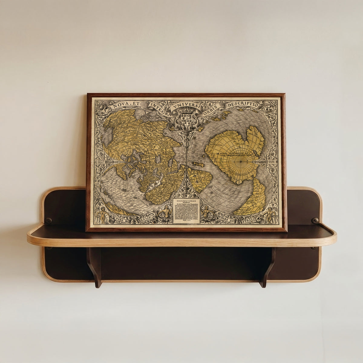 Framed art print of Nova et Integra Universi Orbis Descriptio by Oronce Finé, in a dark wood frame resting on a wall shelf
