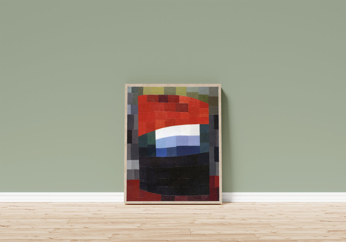 Framed art print of My Sky is Red (Mein Himmel ist rot) (1933) by Otto Freundlich, in a light wood frame leaning on a sage green wall above a wooden floor