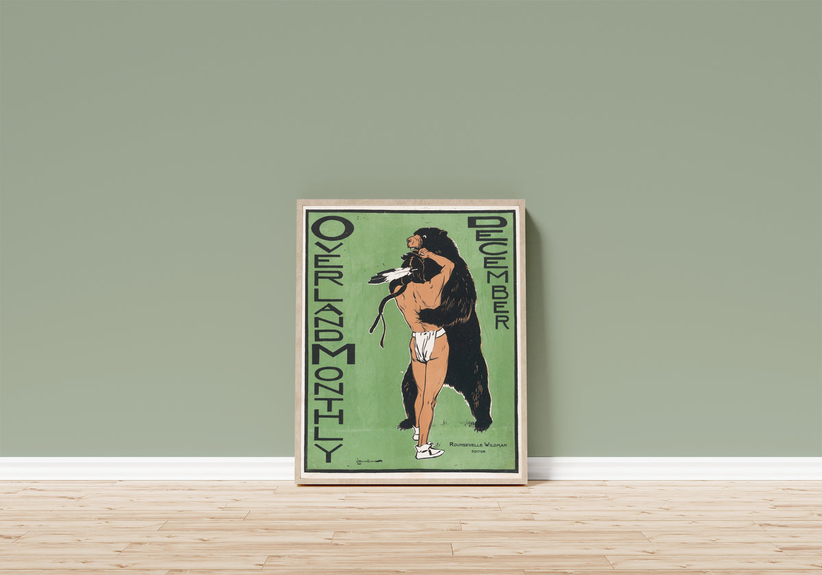 Framed art print of Overland Monthly Cover Art by Maynard Dixon, in a light wood frame leaning on a sage green wall above a wooden floor
