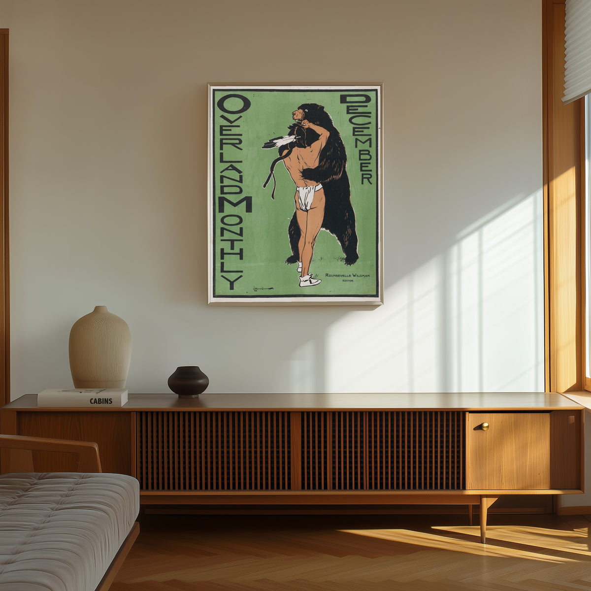 Framed art print of Overland Monthly Cover Art by Maynard Dixon, in a thin light frame on a sunlit wall above a wooden sideboard