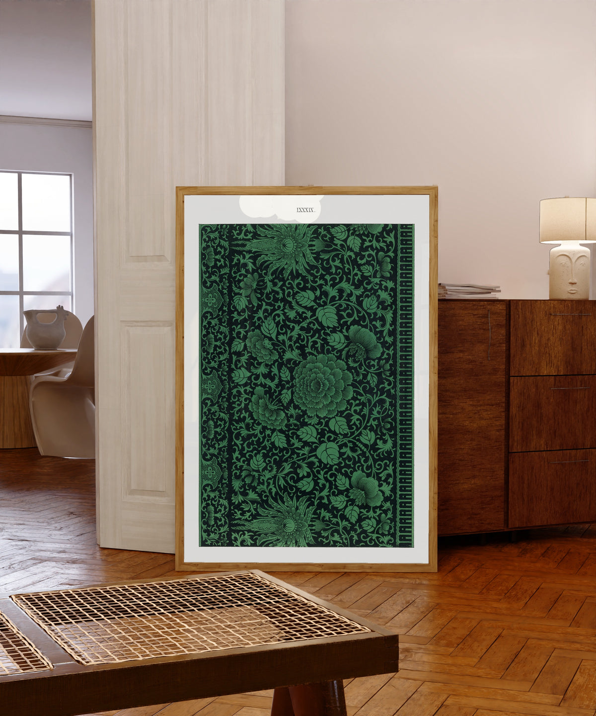 Framed art print of Example of Chinese Ornament Pl.79 (1867) by Owen Jones, in a light wood frame leaning in a warm room with a parquet floor