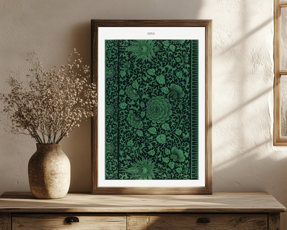 Framed art print of Example of Chinese Ornament Pl.79 (1867) by Owen Jones, in a dark wood frame leaning on a rustic console beside dried flowers