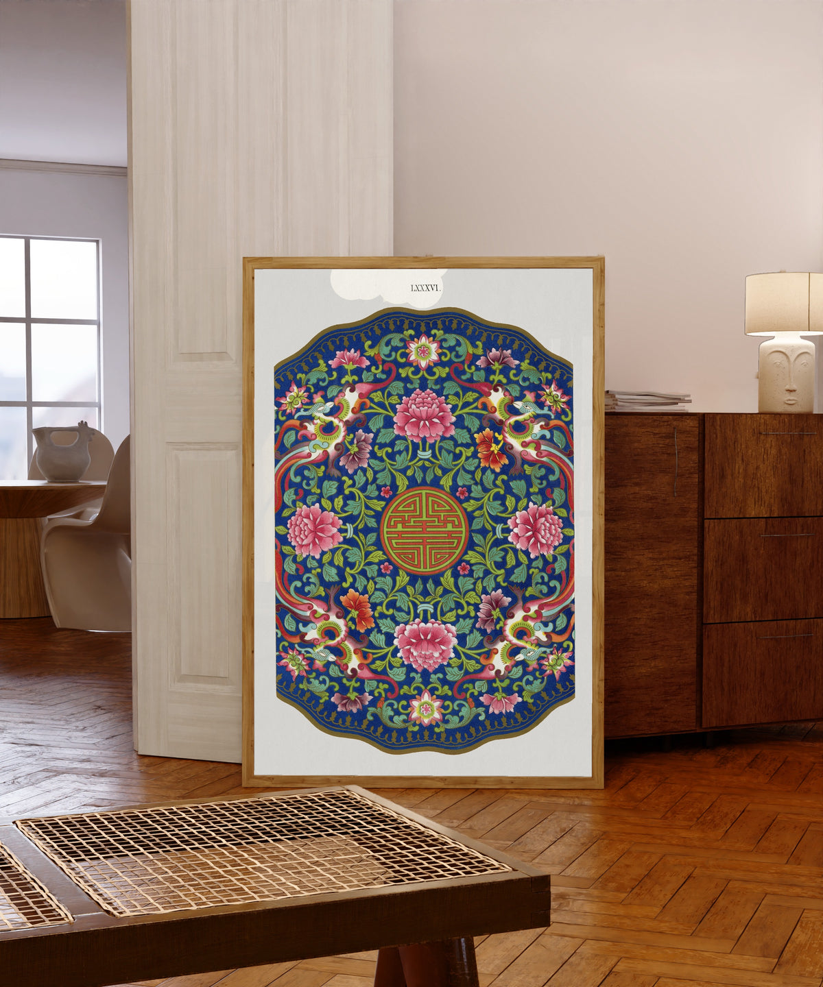 Framed art print of Examples of Chinese Ornament, Plate 86 by Owen Jones, in a light wood frame leaning in a warm room with a parquet floor