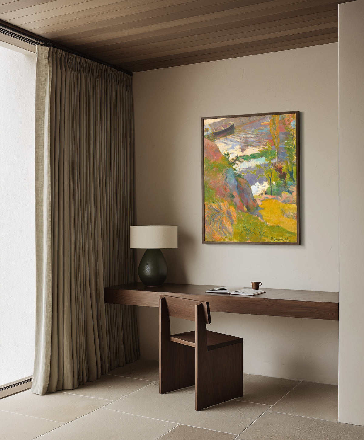 Framed art print of Fisherman and Bathers on the Aven by Paul Gauguin, in a dark wood frame on a plaster wall above a walnut desk