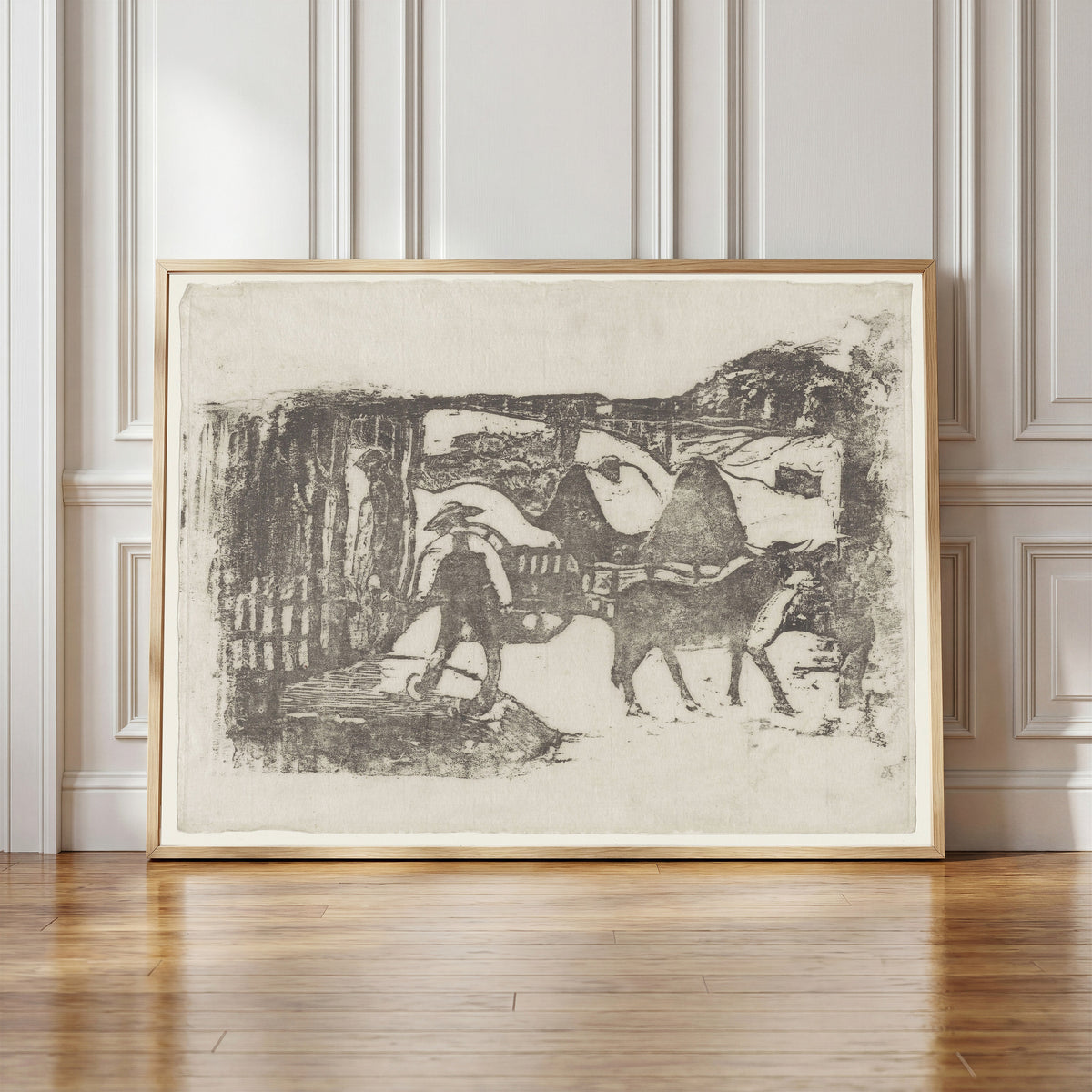 Framed art print of The Ox Cart (Le Char à boeufs) by Paul Gauguin, in a light wood frame leaning against a panelled white wall