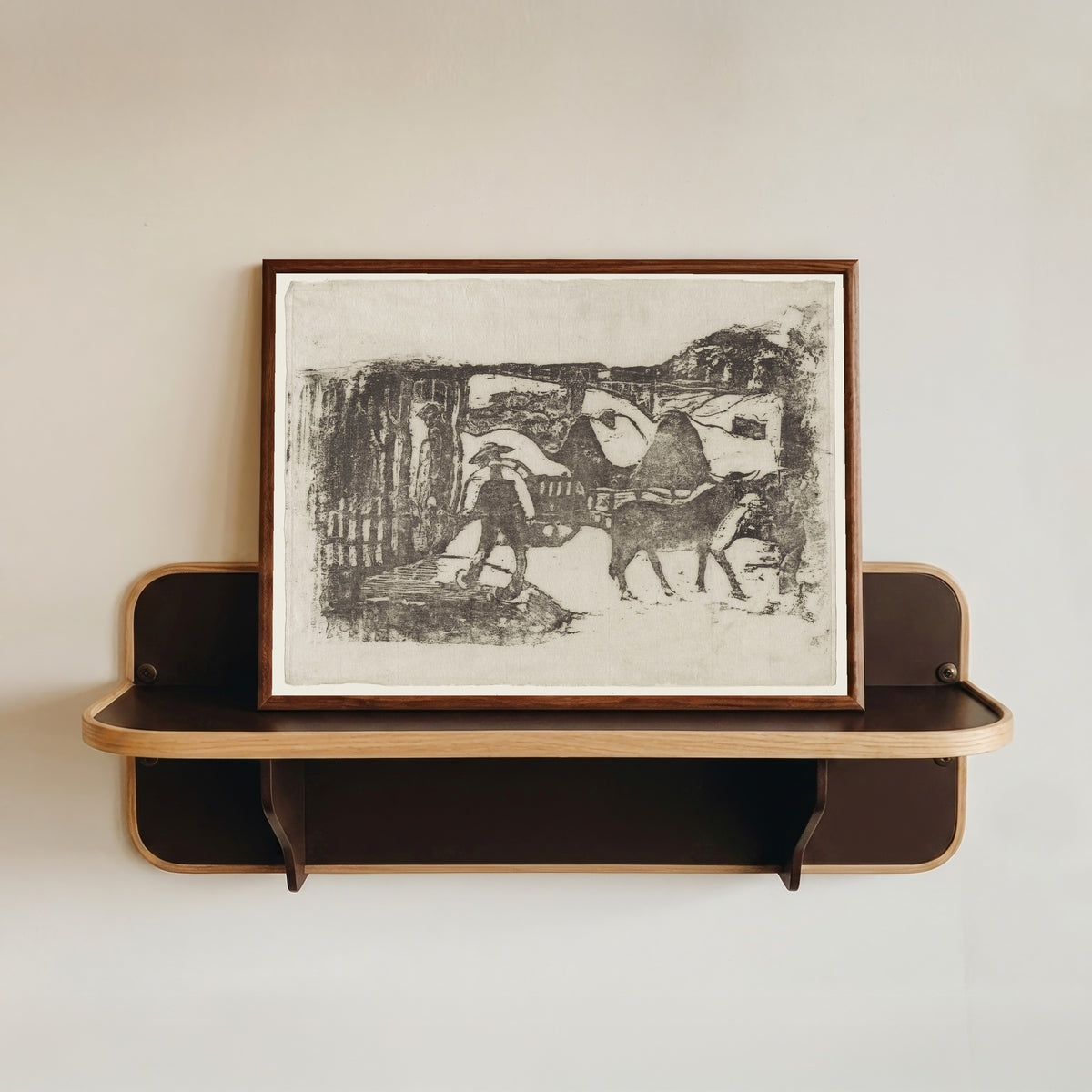 Framed art print of The Ox Cart (Le Char à boeufs) by Paul Gauguin, in a dark wood frame resting on a wall shelf