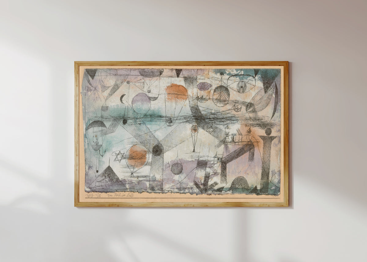 Framed art print of In the Realm of Air (Im Reich der Luft) by Paul Klee, in a light wood frame on a sunlit white wall