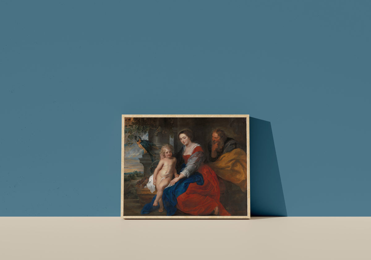 Framed art print of The Holy Family with the Parrot by Peter Paul Rubens, in a light wood frame leaning on a blue wall