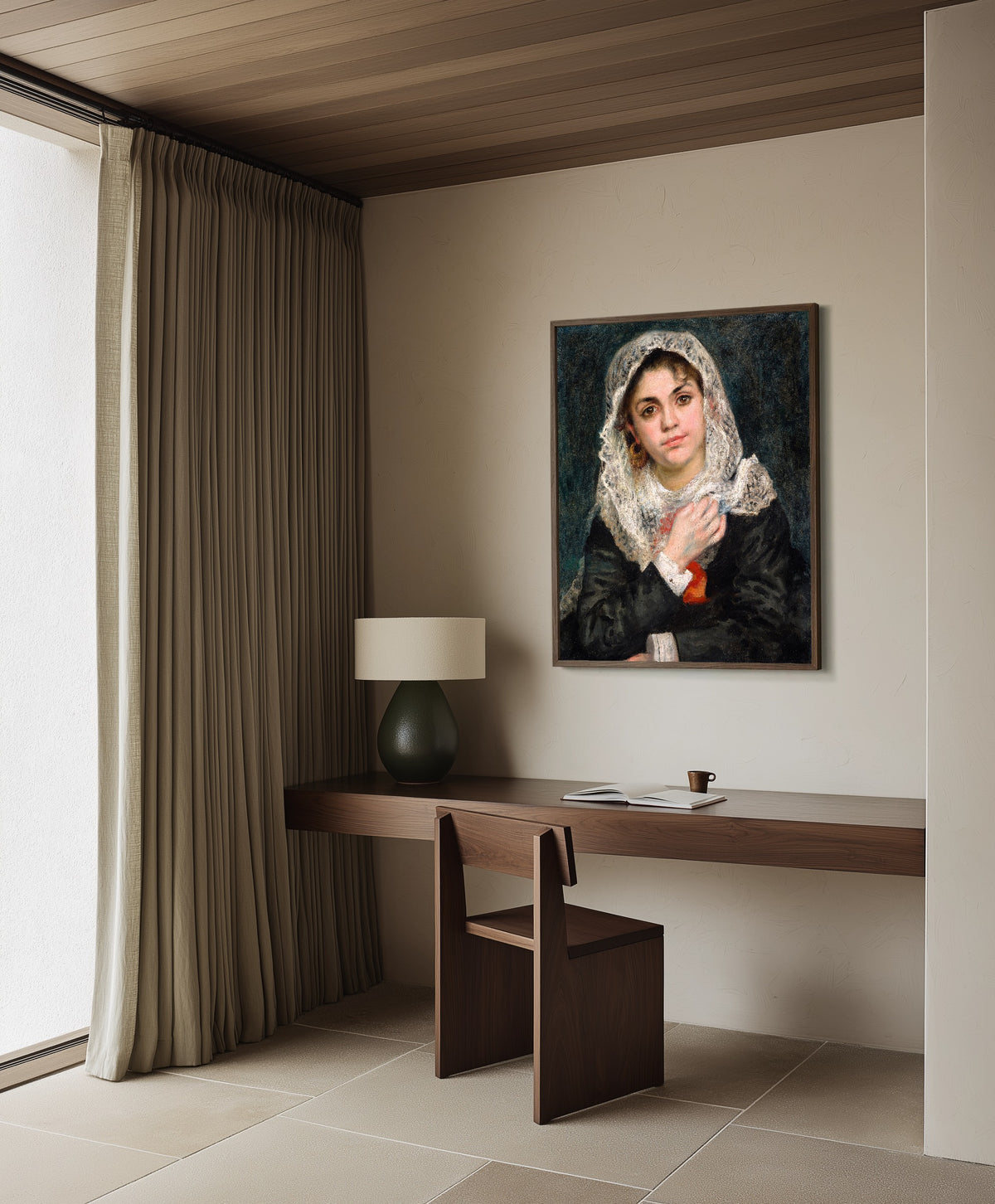 Framed art print of Lise in a White Shawl by Pierre-Auguste Renoir, in a dark wood frame on a plaster wall above a walnut desk