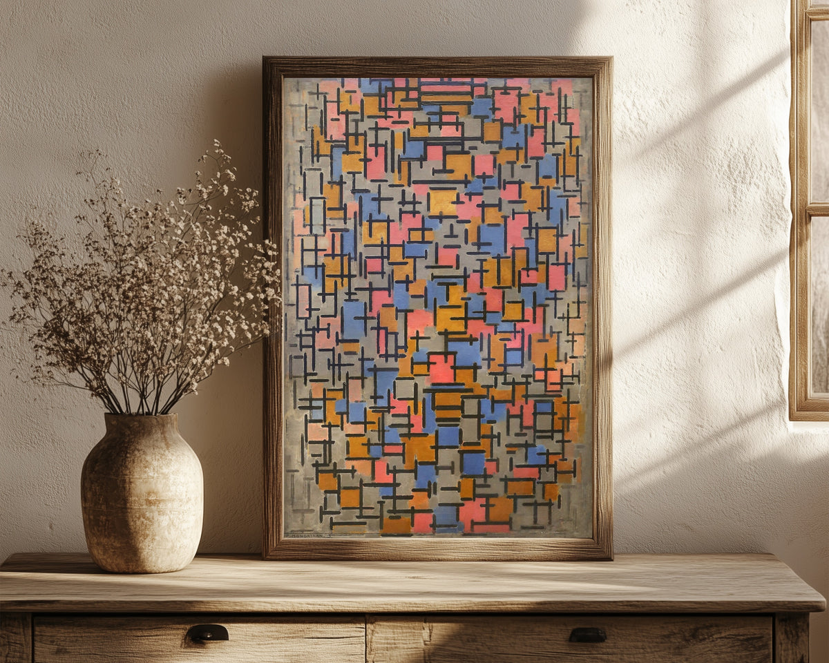 Framed art print of Composition by Piet Mondrian, in a dark wood frame leaning on a rustic console beside dried flowers