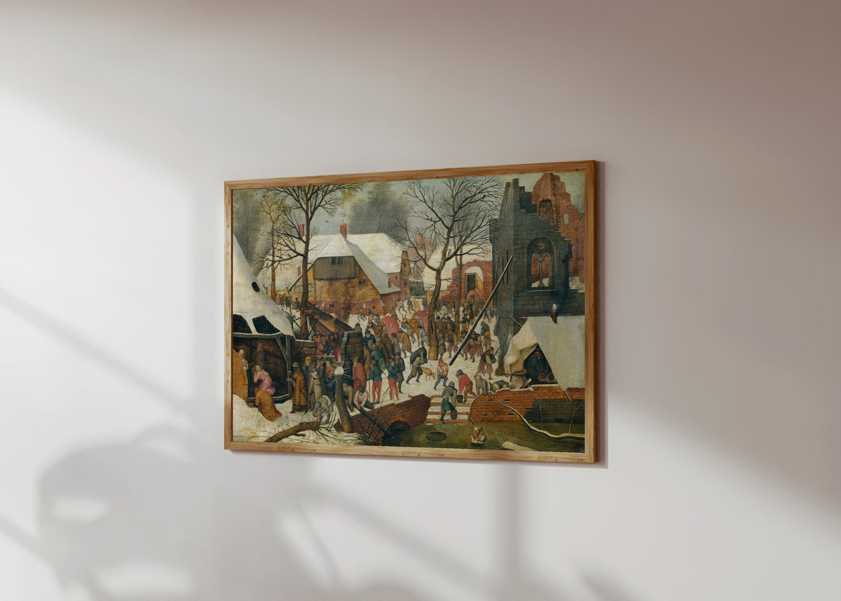 Framed art print of The Adoration of the Magi in the Snow by Pieter Brueghel the Younger, in a light wood frame on a sunlit white wall, seen at a slight angle