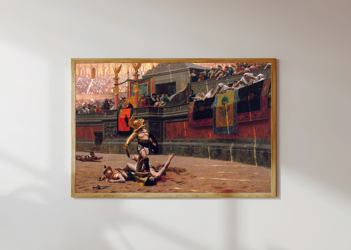 Framed art print of Pollice Verso by Jean-Léon Gérôme, in a light wood frame on a sunlit white wall