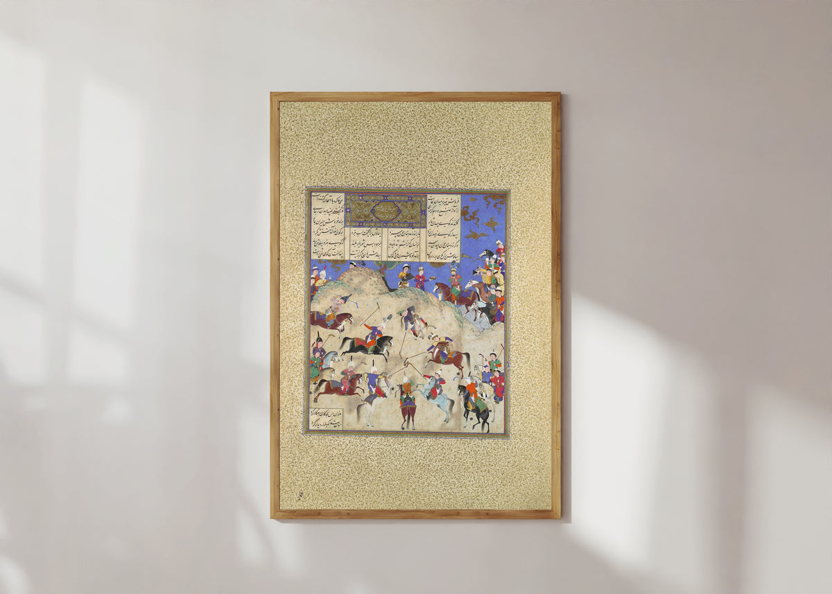 Framed art print of Shahnama of Shah Tahmasp: Siyavush Plays Polo before Afrasiyab by Qasim ibn Ali (attributed), in a light wood frame on a sunlit white wall