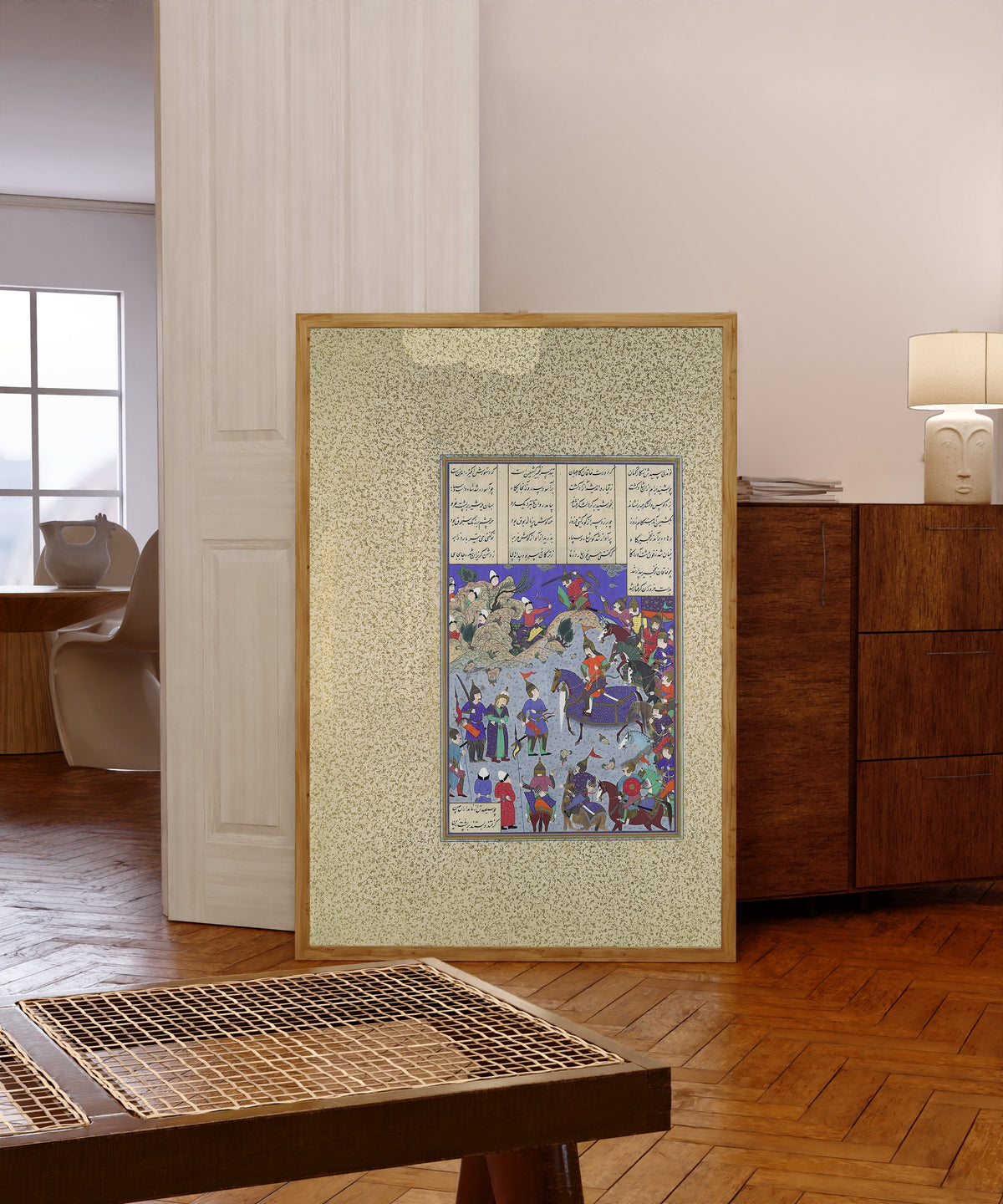 Framed art print of Shahnama of Shah Tahmasp: The Khaqan… by Qasim ibn Ali (attributed), in a light wood frame leaning in a warm room with a parquet floor