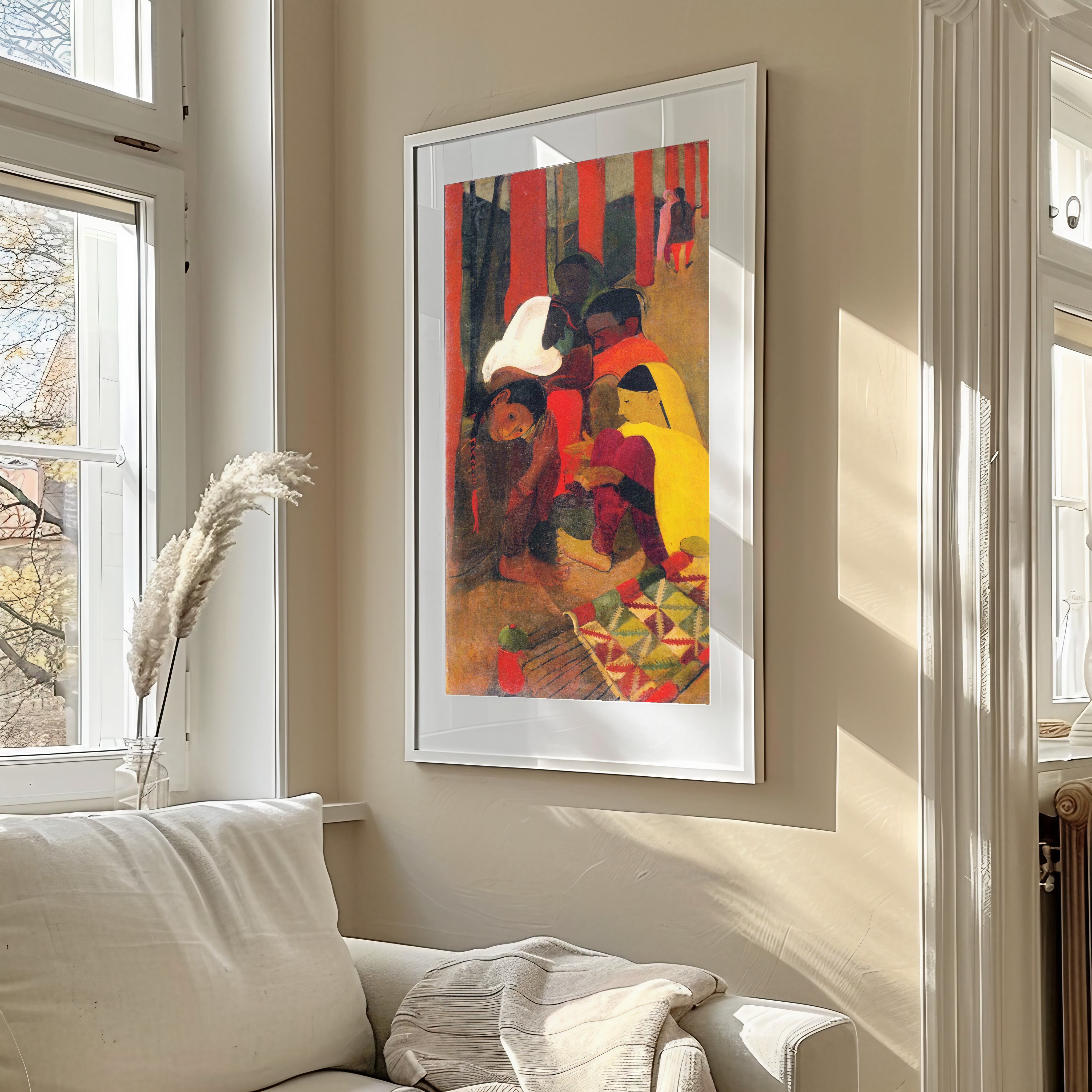 A framed art print featuring a vibrant, impressionistic painting of figures in a market, hung on a beige wall above a white sofa in a sunlit living room.