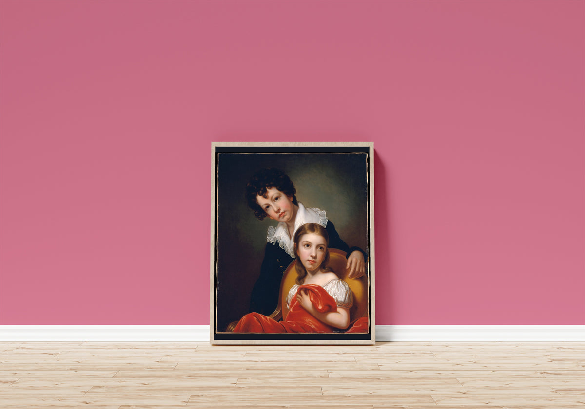 Framed art print of Michael Angelo and Emma Clara Peale by Rembrandt Peale, in a light wood frame leaning on a pink wall above a wooden floor
