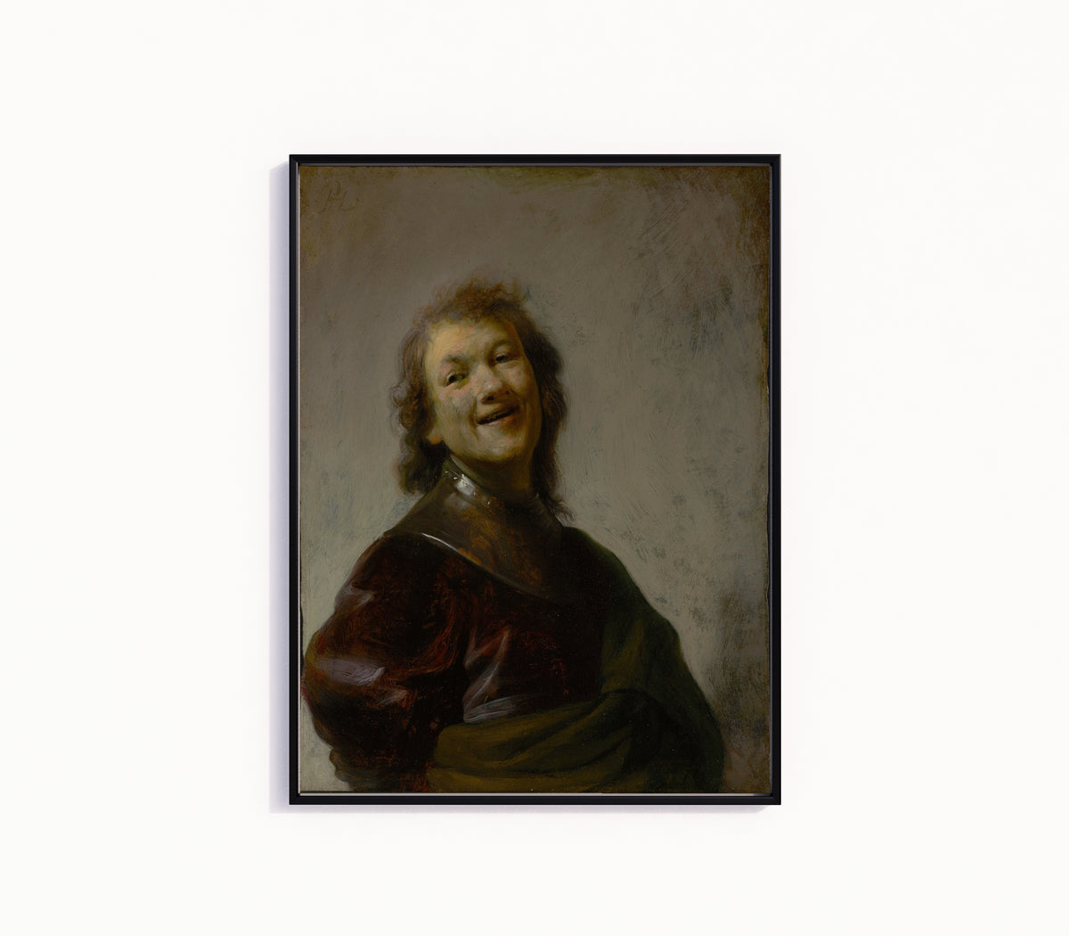 Framed art print of Rembrandt Laughing by Rembrandt van Rijn, in a slim black frame on a plain white wall