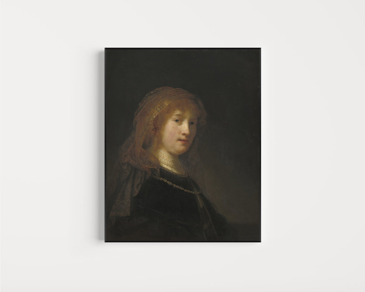Framed art print of Saskia van Uylenburgh, the Wife of the Artist by Rembrandt van Rijn, in a slim black frame on a plain white wall