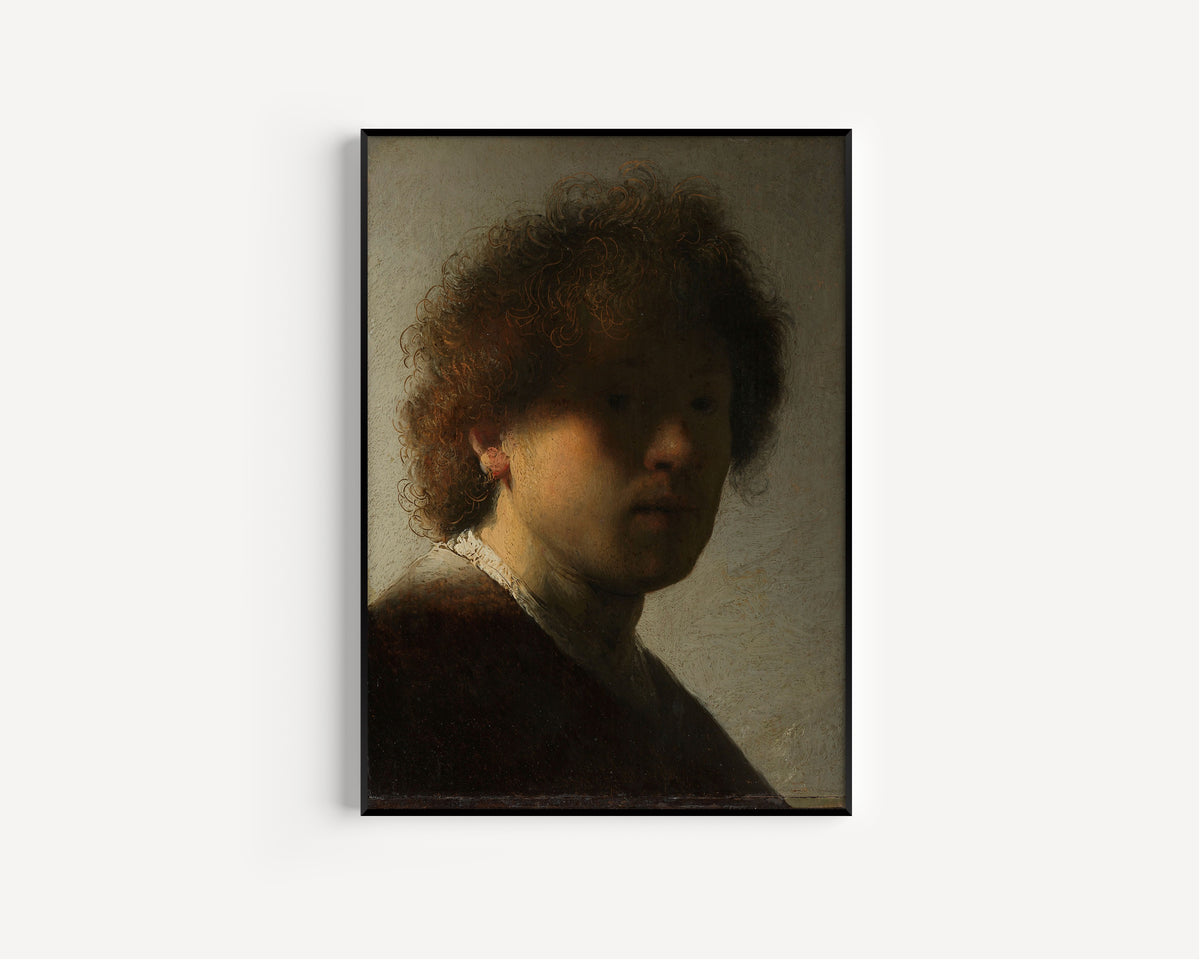 Self-portrait by Rembrandt van Rijn — in a slim black frame on a plain white wall