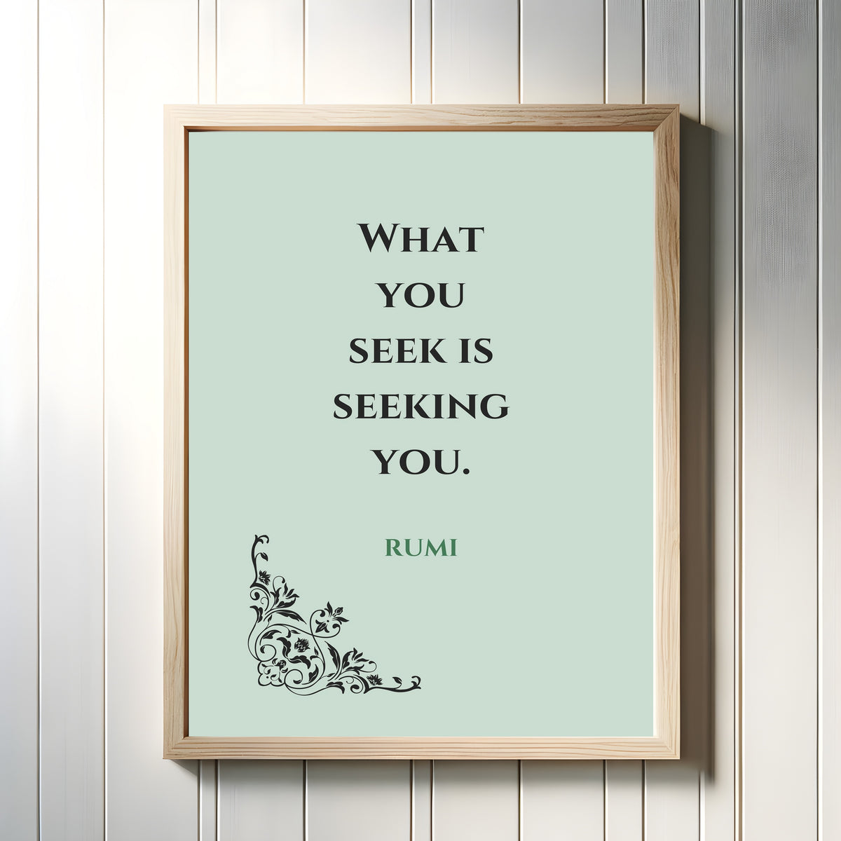 Framed art print of Seek by Rumi, in a light wood frame on a white panelled wall
