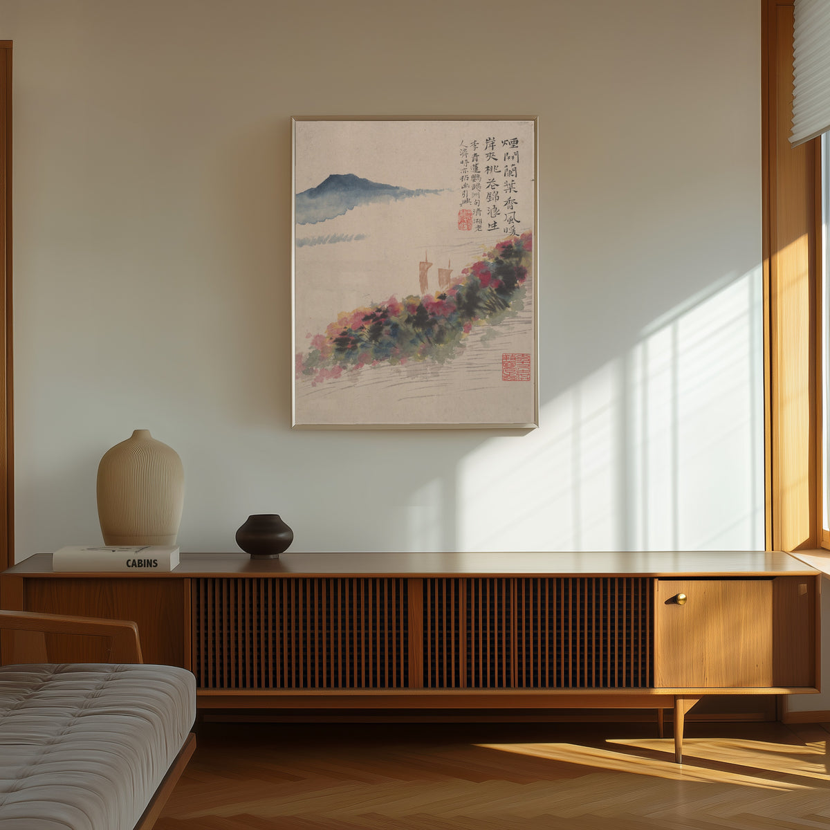 Framed art print of Wilderness Colors (Peach Blossom Bank and Two Sails) by Shitao, in a thin light frame on a sunlit wall above a wooden sideboard