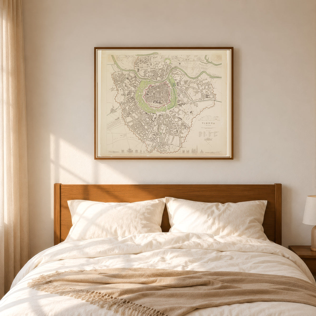 Framed art print of Vienna by Society for the Diffusion of Useful Knowledge, in a slim wood frame above a bed in a sunlit bedroom