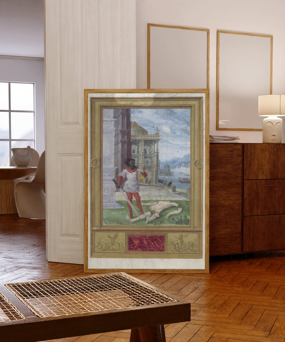 Framed art print of The Dismemberment by Splendor Solis, in a light wood frame leaning in a warm room with a parquet floor