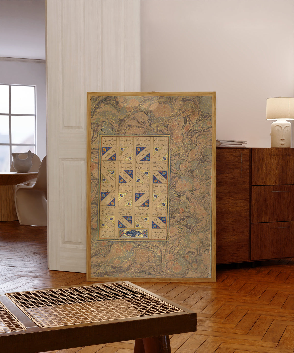 Framed art print of Page of Calligraphy from a Mantiq al-Tayr… by Sultan 'Ali al-Mashhadi, in a light wood frame leaning in a warm room with a parquet floor