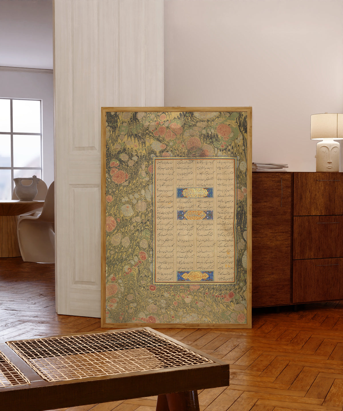 Framed art print of Page of Calligraphy from a Mantiq al-Tayr… by Sultan 'Ali al-Mashhadi, in a light wood frame leaning in a warm room with a parquet floor
