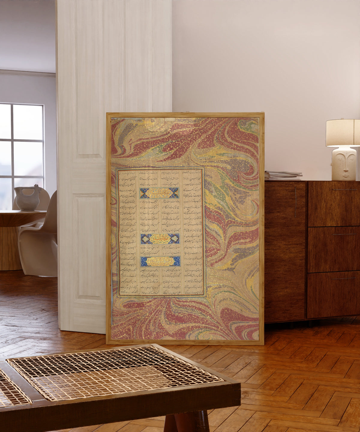 Framed art print of Page of Calligraphy from a Mantiq al-Tayr… by Sultan 'Ali al-Mashhadi, in a light wood frame leaning in a warm room with a parquet floor