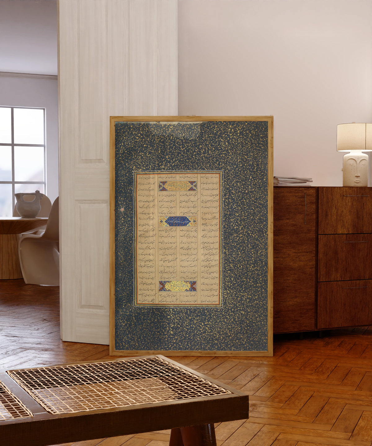 Framed art print of Page of Calligraphy from a Mantiq al-Tayr… by Sultan 'Ali al-Mashhadi, in a light wood frame leaning in a warm room with a parquet floor