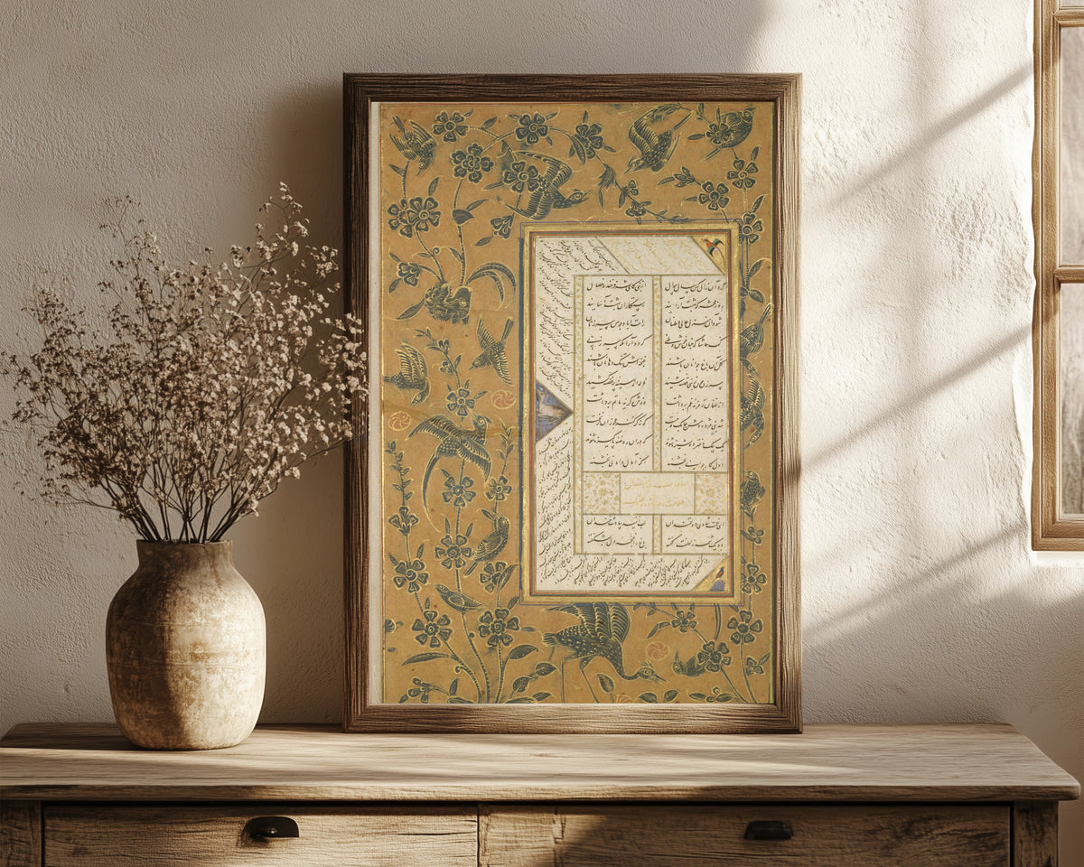 Framed art print of Page of Calligraphy with Stenciled and… by Sultan 'Ali al-Mashhadi, in a dark wood frame leaning on a rustic console beside dried flowers