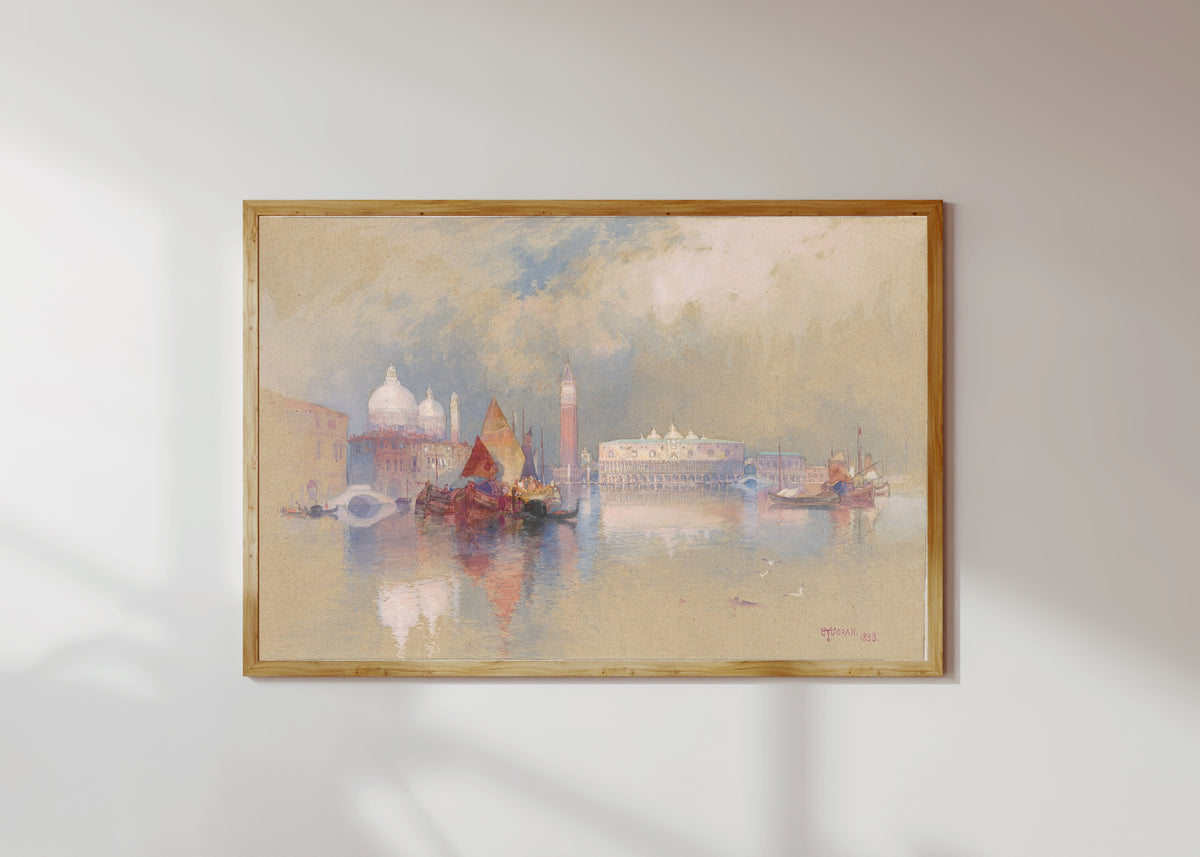 Framed art print of View of Venice by Thomas Moran, in a light wood frame on a sunlit white wall