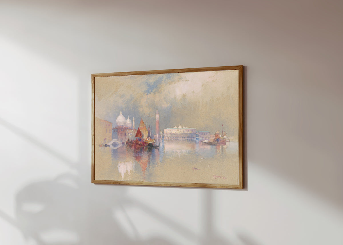 Framed art print of View of Venice by Thomas Moran, in a light wood frame on a sunlit white wall, seen at a slight angle
