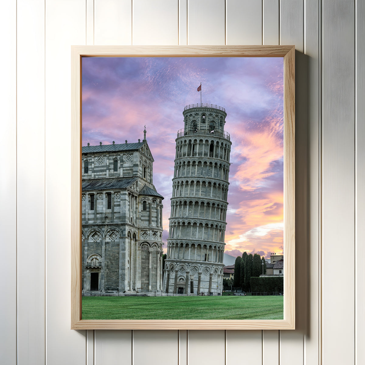 Framed art print of Tower of Pisa by Pablo Meilán Campagnale, in a light wood frame on a white panelled wall