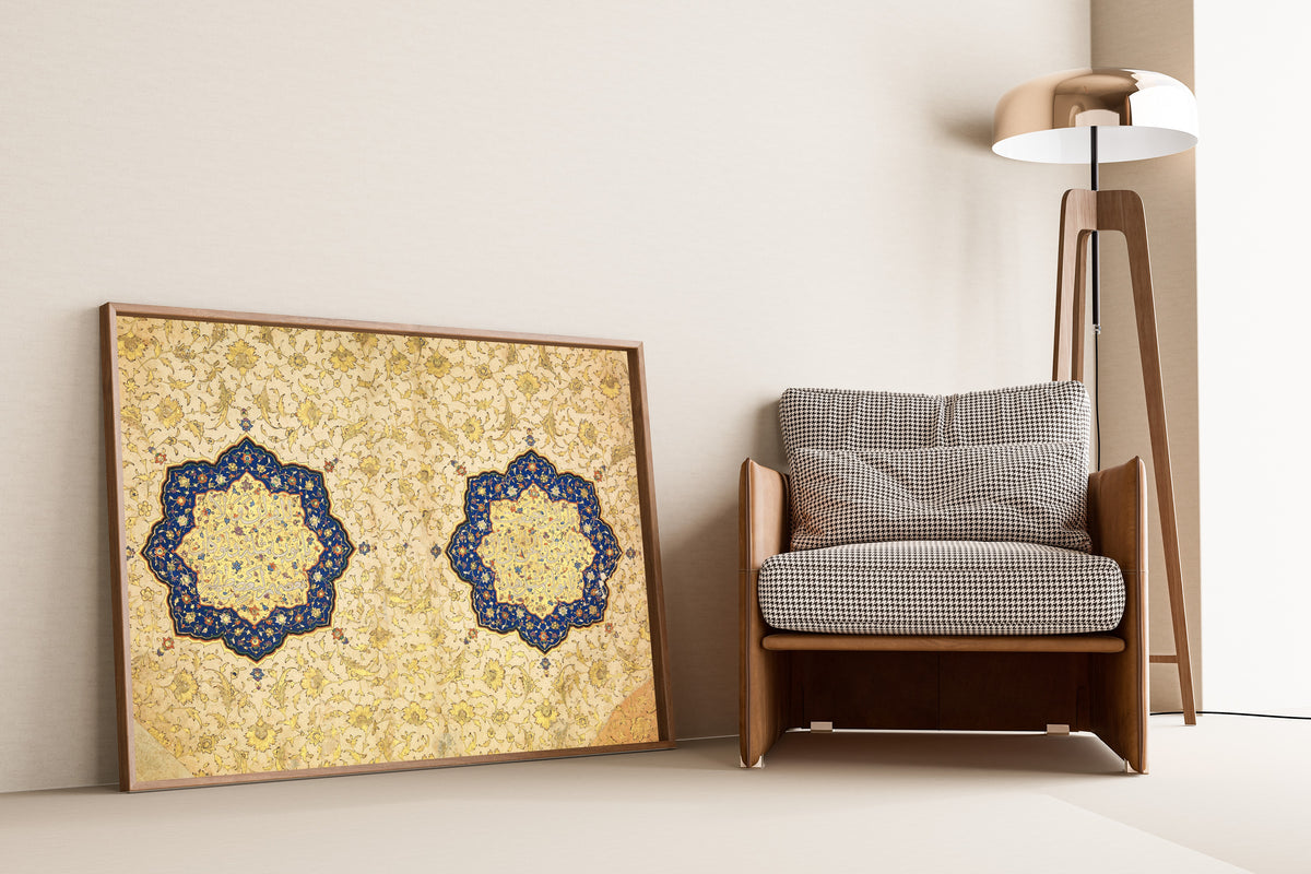 Illuminated Qur'an Opening by Ibrahim Sultan — framed and leaning against a wall beside an armchair and a floor lamp
