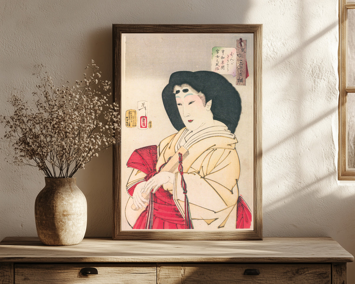 Framed art print of Looks Refined (Kyōwa-era Court Lady) by Tsukioka Yoshitoshi, in a dark wood frame leaning on a rustic console beside dried flowers