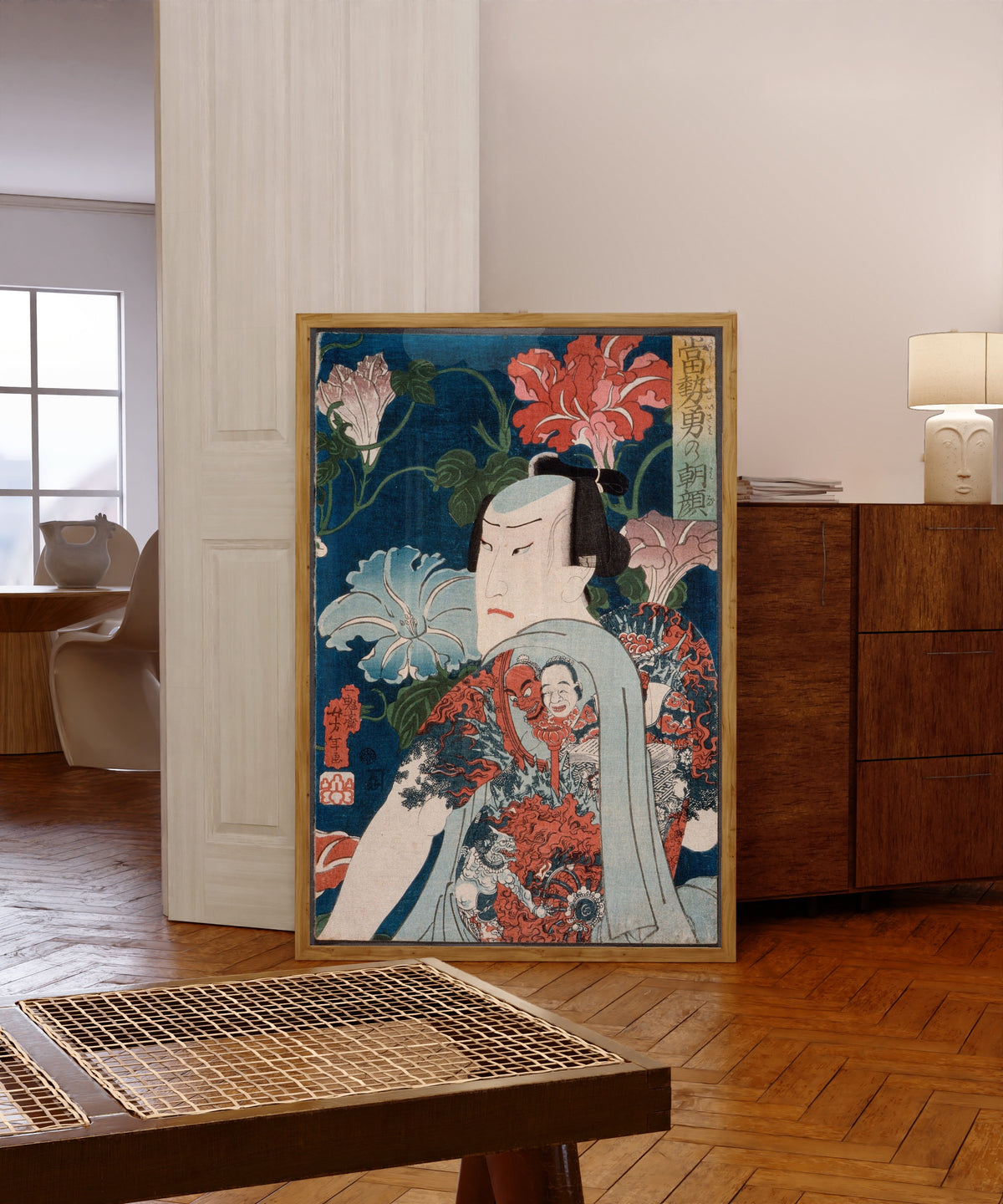 Framed art print of Modern Gallants with Morning Glories by Tsukioka Yoshitoshi, in a light wood frame leaning in a warm room with a parquet floor