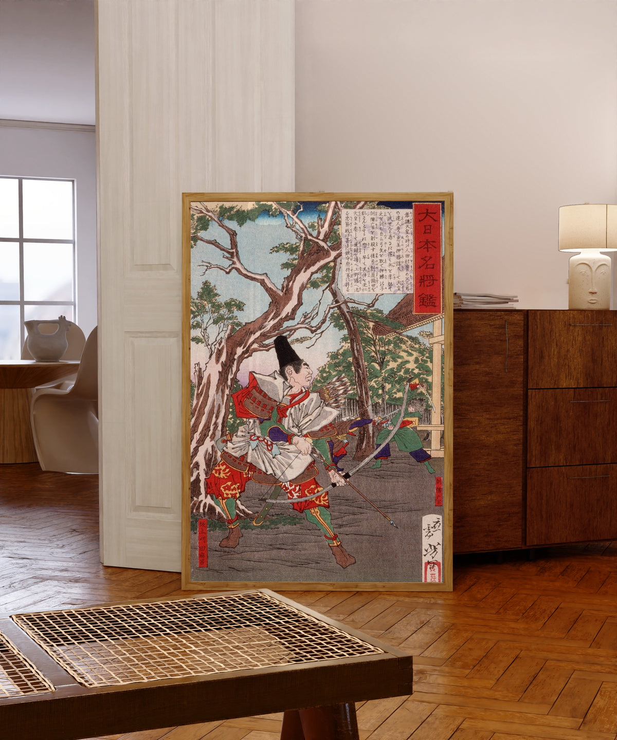 Framed art print of Sakanoue no Karitamaro Drawing His Bow by Tsukioka Yoshitoshi, in a light wood frame leaning in a warm room with a parquet floor
