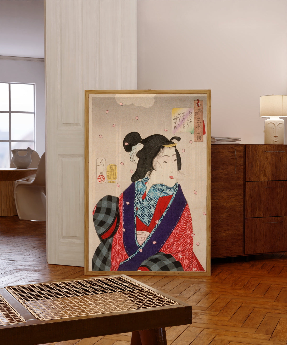 Framed art print of Wanting to Meet Someone: A Courtesan of the Kaei… by Tsukioka Yoshitoshi, in a light wood frame leaning in a warm room with a parquet floor