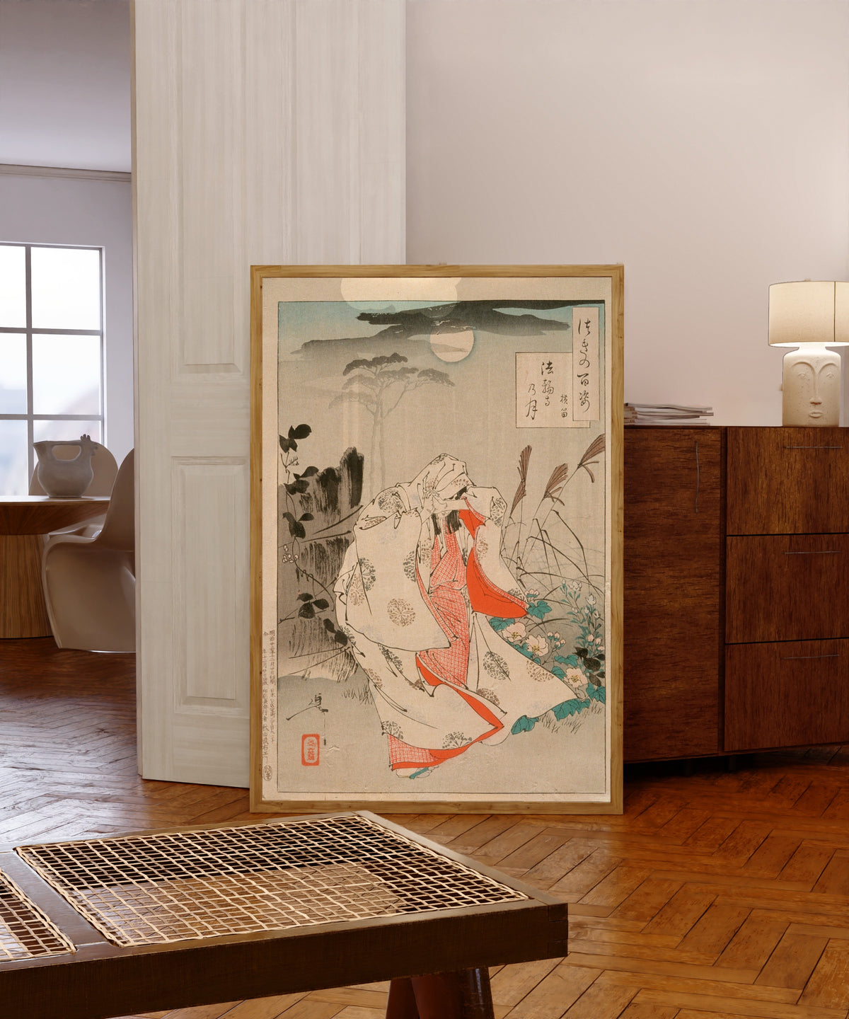 Framed art print of Yokobue Waiting from Takiguchi Tokiyori by Tsukioka Yoshitoshi, in a light wood frame leaning in a warm room with a parquet floor