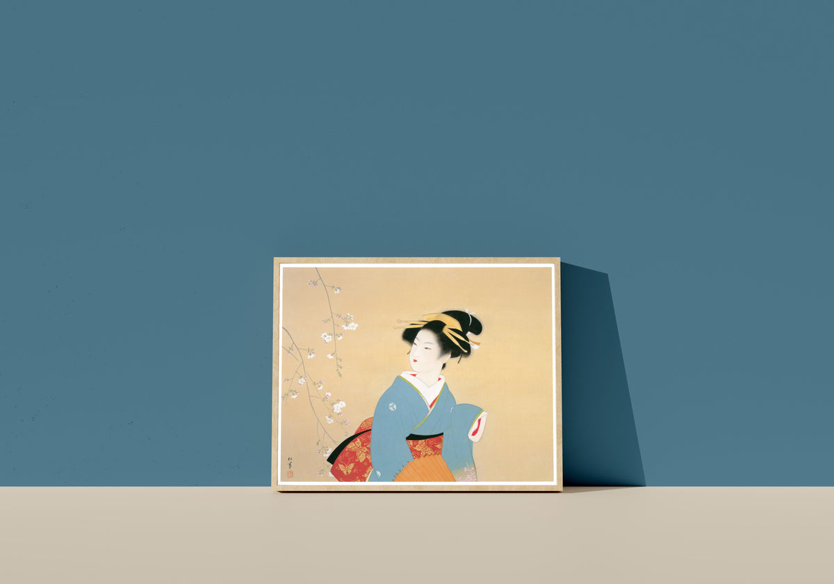 Framed art print of Cherry Blossom Viewing by Uemura Shōen, in a light wood frame leaning on a blue wall