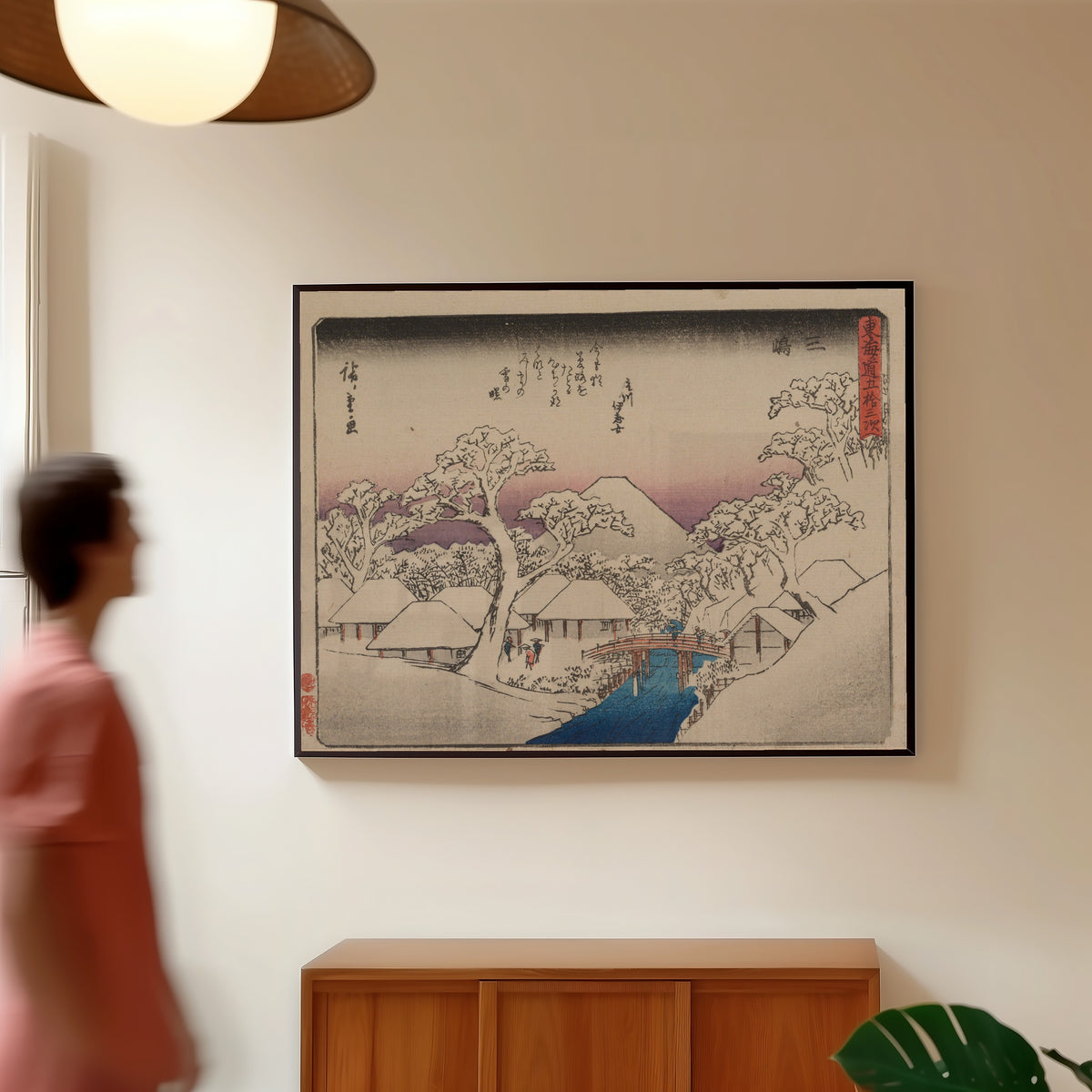 Framed art print of Kyōka Tōkaidō: Mishima by Utagawa Hiroshige, in a slim black frame on a warm wall in a sunlit room